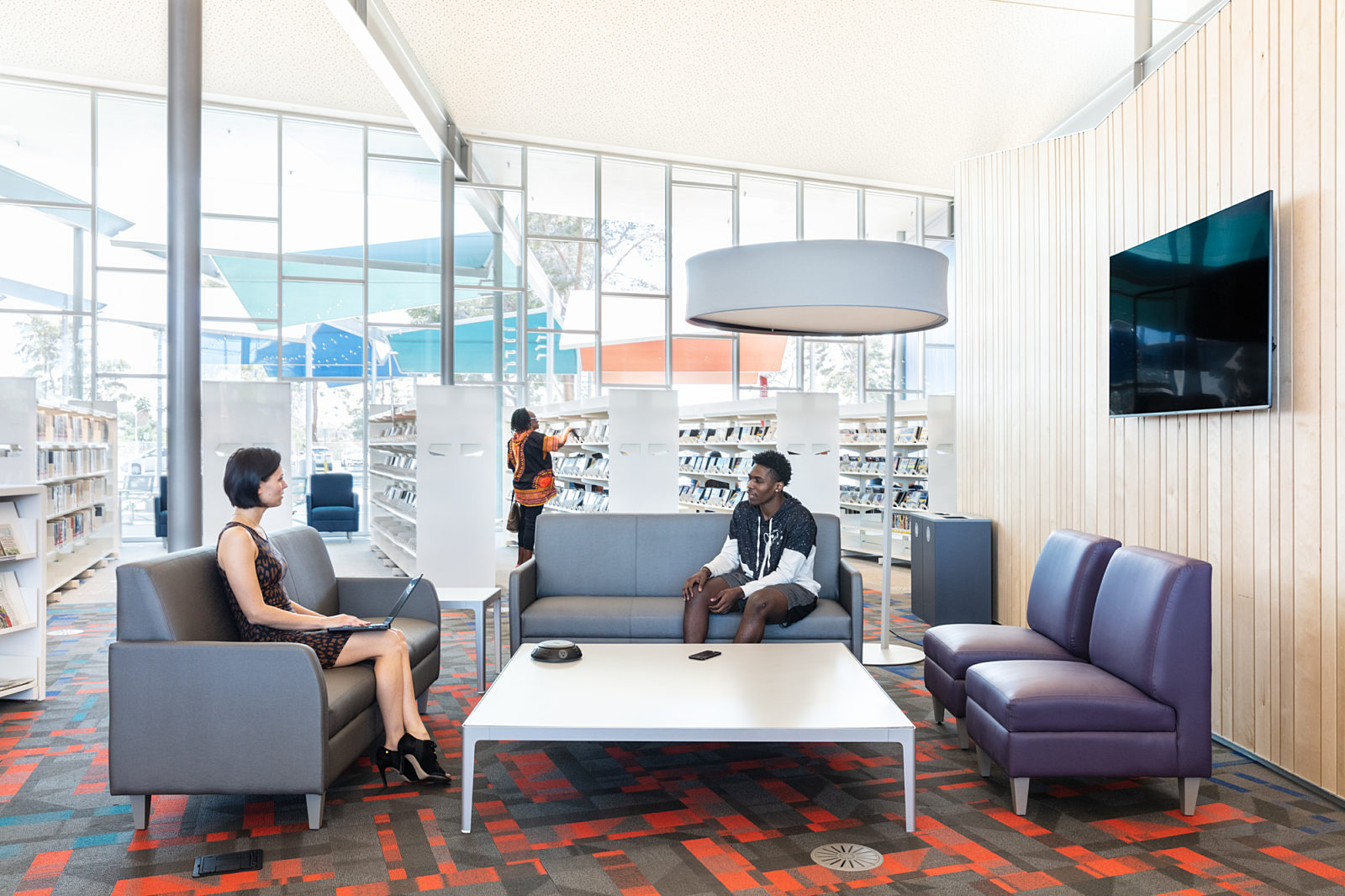 Modern commercial interior furnished with comfortable seating and open workspace design